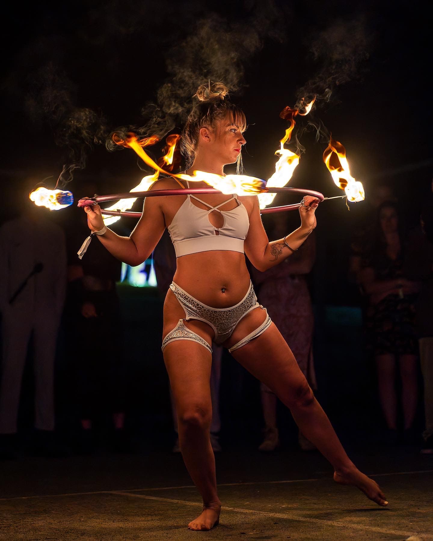 Alyssa performing a pole pose outdoors in a tropical setting
